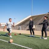 Student athletic trainers work with a student athlete. 